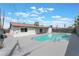 Backyard pool surrounded by concrete with a railing that provides a way to cool off in the summer heat at 1808 E Saint Louis Ave, Las Vegas, NV 89104
