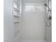 Bright white tiled shower with shelves and modern fixture at 1808 E Saint Louis Ave, Las Vegas, NV 89104
