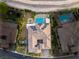 A bird's eye view captures a home with a unique roof design, accented by solar panels and a pool at 21 Grand Masters Dr, Las Vegas, NV 89141