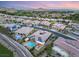 Expansive aerial view of a community with a home featuring a pool and solar panels at sunset at 21 Grand Masters Dr, Las Vegas, NV 89141