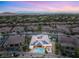A high angle view of an upscale community featuring a home with a private pool and solar panels at 21 Grand Masters Dr, Las Vegas, NV 89141