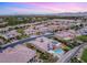 High-angle shot of a luxury neighborhood, focusing on a home with a backyard pool and solar panel roofing at 21 Grand Masters Dr, Las Vegas, NV 89141