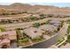 Elevated view showcases a home with desert landscaping, nestled near the picturesque mountain range at 21 Grand Masters Dr, Las Vegas, NV 89141