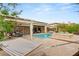 Inviting backyard featuring a pool, spa, covered patio, and a relaxing hammock at 21 Grand Masters Dr, Las Vegas, NV 89141