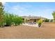Spacious backyard with a fire pit, patio, and a pergola with outdoor seating at 21 Grand Masters Dr, Las Vegas, NV 89141
