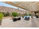 Outdoor living space with a fire pit, lounge chairs, and stunning rock wall backdrop at 21 Grand Masters Dr, Las Vegas, NV 89141