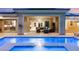 Backyard pool and lounge area featuring a covered patio and exterior lighting at 21 Grand Masters Dr, Las Vegas, NV 89141
