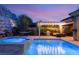 Beautiful backyard features a pool, hot tub, hammock, and a built-in BBQ area for outdoor entertaining at 21 Grand Masters Dr, Las Vegas, NV 89141