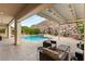 Backyard featuring a pool, spa, and patio area with comfortable seating under a pergola at 21 Grand Masters Dr, Las Vegas, NV 89141