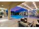 A covered outdoor space features views of the pool, hot tub, rock wall and desert landscape at 21 Grand Masters Dr, Las Vegas, NV 89141