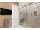 Modern bathroom featuring a glass-enclosed shower with dual shower heads and a tiled accent wall at 21 Grand Masters Dr, Las Vegas, NV 89141