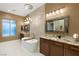 Elegant bathroom with a soaking tub, dual sinks, and modern lighting at 21 Grand Masters Dr, Las Vegas, NV 89141