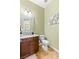 Compact powder room featuring a granite countertop, decorative mirror, and tile floors at 21 Grand Masters Dr, Las Vegas, NV 89141