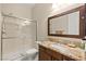Standard bathroom with a shower over tub, granite countertops, and wooden cabinets at 21 Grand Masters Dr, Las Vegas, NV 89141