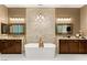 Luxurious bathroom featuring a soaking tub, dual sinks, and modern fixtures at 21 Grand Masters Dr, Las Vegas, NV 89141