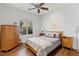 Cozy bedroom with wood floors, a ceiling fan, and natural light from the window at 21 Grand Masters Dr, Las Vegas, NV 89141