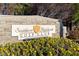 Stone sign reads 'Southern Highlands Golf Club' with gold shield accent and flowerbed in a beautiful outdoor setting at 21 Grand Masters Dr, Las Vegas, NV 89141