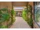 Unique covered entryway with pavers, mature trees, and a clear view to the backyard patio at 21 Grand Masters Dr, Las Vegas, NV 89141