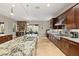 Modern kitchen with granite counters, stainless appliances, and wine storage near a dining space at 21 Grand Masters Dr, Las Vegas, NV 89141