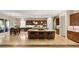 Open kitchen featuring a large island with seating, stainless appliances, and dining area at 21 Grand Masters Dr, Las Vegas, NV 89141