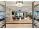 Spacious living room with sleek tile floors, a stone fireplace, a view of the pool, and modern furnishings at 21 Grand Masters Dr, Las Vegas, NV 89141