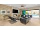 Spacious living room featuring a fireplace, tile flooring, a ceiling fan, and sliding doors to the pool at 21 Grand Masters Dr, Las Vegas, NV 89141