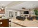 Spacious living room featuring a stone fireplace, tile floors, and modern furnishings at 21 Grand Masters Dr, Las Vegas, NV 89141