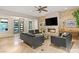 Comfortable living room showcasing a stone fireplace, tile flooring, a ceiling fan, and contemporary furnishings at 21 Grand Masters Dr, Las Vegas, NV 89141