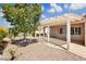 Backyard featuring a covered patio, rock landscaping, mature trees and desert-style shrubs at 2163 Bannerwood St, Henderson, NV 89044