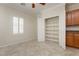Bright bedroom features neutral walls, window shutters, ceiling fan and an open closet at 2163 Bannerwood St, Henderson, NV 89044