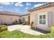 Welcoming front courtyard featuring a charming arrangement of landscaping, hardscape, and architectural details at 2163 Bannerwood St, Henderson, NV 89044