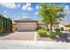 Charming single-story home featuring a brick driveway and manicured landscaping under a bright blue sky at 2163 Bannerwood St, Henderson, NV 89044