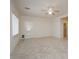 Spacious living room with tile flooring, ceiling fan, and natural light from the windows and door at 2163 Bannerwood St, Henderson, NV 89044