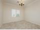 A room with neutral walls, beautiful window shutters, and elegant lighting fixture at 2163 Bannerwood St, Henderson, NV 89044