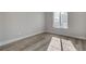 This light-filled bedroom features wood-look floors and a bright sunny window at 2212 Warm Walnut Dr, Las Vegas, NV 89134