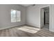 Bright bedroom with wood-look floors with a large window and closet nearby at 2212 Warm Walnut Dr, Las Vegas, NV 89134