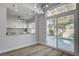 Dining area with counter seating, opening to a well-equipped kitchen and backyard pool at 2212 Warm Walnut Dr, Las Vegas, NV 89134