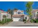 Charming two-story stucco home featuring a red tile roof and attached two-car garage at 2212 Warm Walnut Dr, Las Vegas, NV 89134