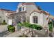 Charming stucco home with a gated walkway and lush landscaped front yard at 2212 Warm Walnut Dr, Las Vegas, NV 89134
