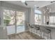 Kitchen bar with seating opens to bright dining area with views of the pool and living area at 2212 Warm Walnut Dr, Las Vegas, NV 89134