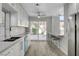 Updated kitchen with stainless steel appliances, sleek countertops, and a bar overlooking the backyard pool at 2212 Warm Walnut Dr, Las Vegas, NV 89134