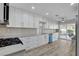 Modern kitchen with white cabinets, stainless steel appliances, and backyard access at 2212 Warm Walnut Dr, Las Vegas, NV 89134