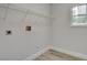 This laundry room offers hookups, shelving, and a window for natural light at 2212 Warm Walnut Dr, Las Vegas, NV 89134