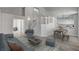 Open-concept living room with staircase, dining area, and wood flooring at 2212 Warm Walnut Dr, Las Vegas, NV 89134