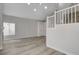 Inviting living room features wood-look flooring, natural light, and staircase to the upper level at 2212 Warm Walnut Dr, Las Vegas, NV 89134