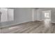 A bright, empty living room with wood-look floors at 2212 Warm Walnut Dr, Las Vegas, NV 89134