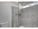 Sleek bathroom shower with gray marble tile and modern glass enclosure at 2212 Warm Walnut Dr, Las Vegas, NV 89134