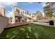 This backyard features a wooden deck, grass area, barbecue grill, patio area, and two-story house at 2416 Sun Shores Dr, Las Vegas, NV 89128