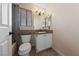 Powder room featuring tile flooring, granite countertop, and tiled backsplash at 2416 Sun Shores Dr, Las Vegas, NV 89128
