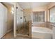 This bathroom includes a glass shower and a white soaking tub near a window at 2416 Sun Shores Dr, Las Vegas, NV 89128